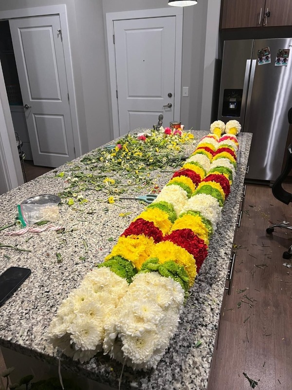 Large, heavy traditional South Asian flower garland on display