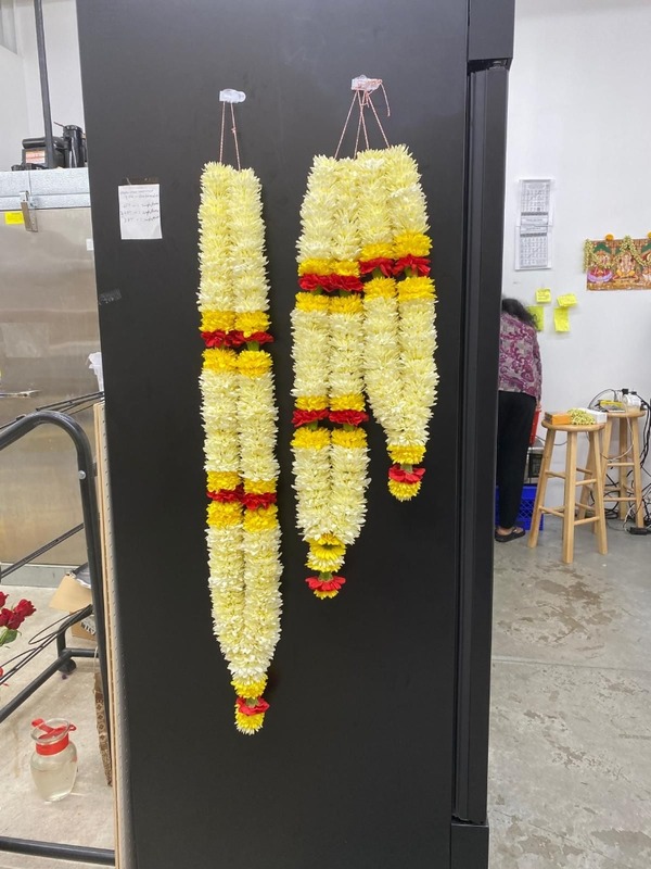 Vibrant yellow, white, and red garlands hanging vertically